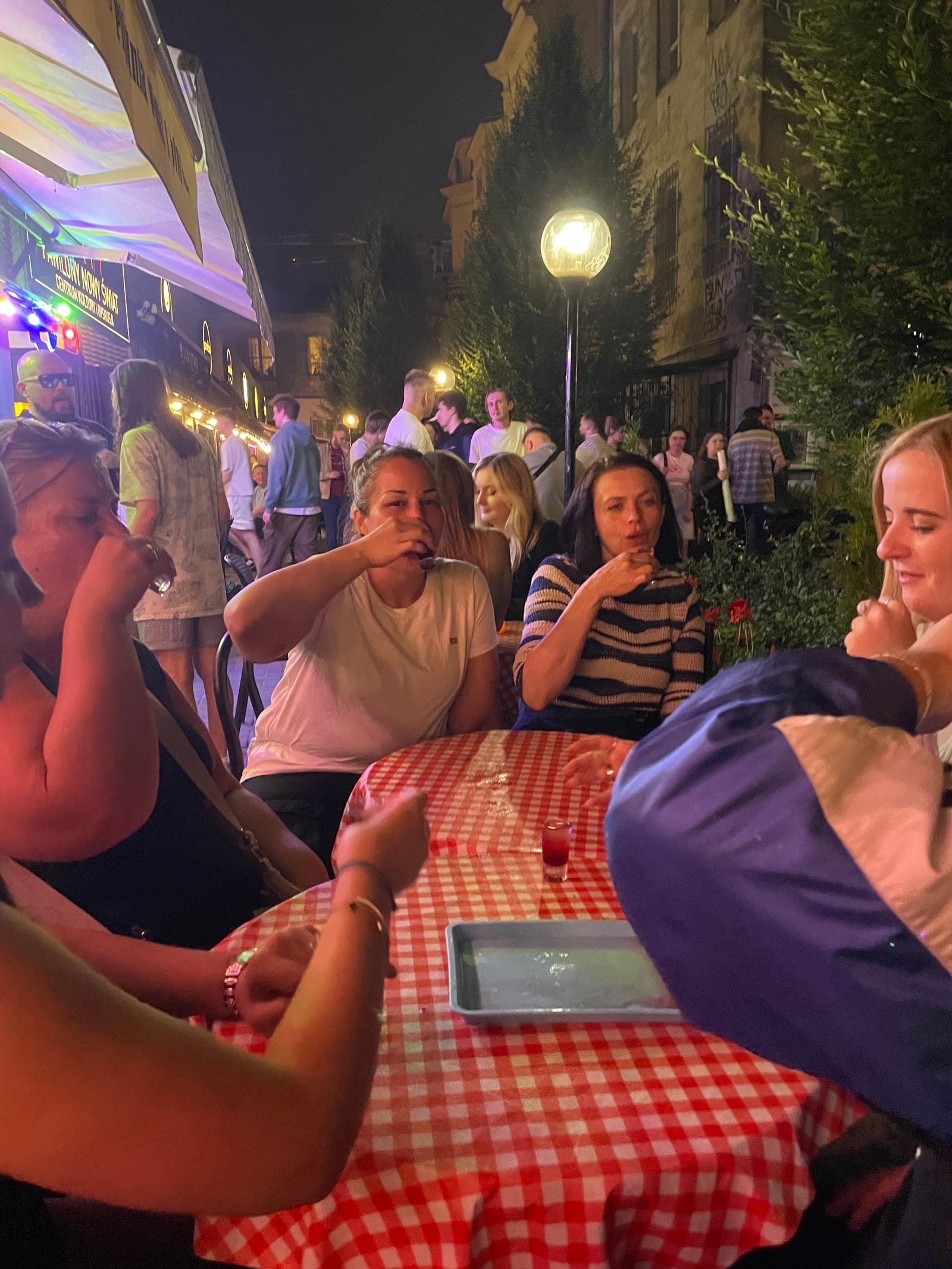 Evening tour group at a candlelit Warsaw outdoor table