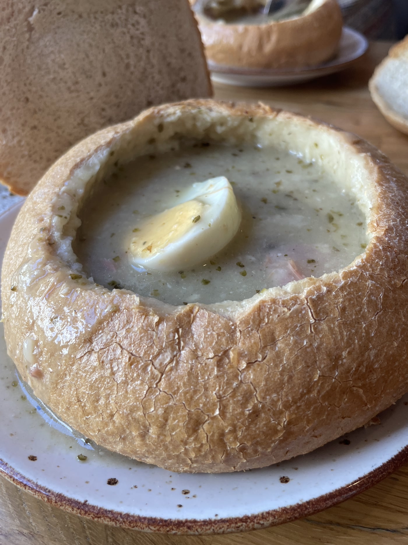 Żurek soup in a sourdough bread bowl served on the Traditional Polish Food Tour in Warsaw