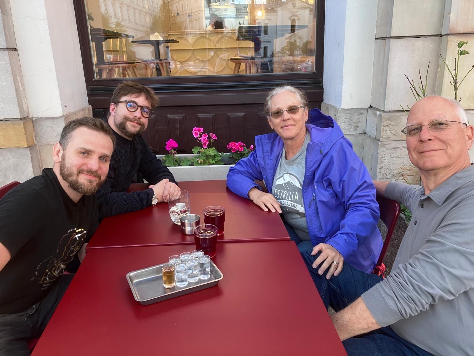 Warsaw food tour guests with a tasting tray at an outdoor café table